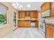 Bright kitchen features wood cabinets, granite counters and white appliances at 2698 S Niagara St, Denver, CO 80224