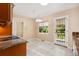 Bright kitchen featuring tile floors, a window above the sink, and a door leading outside at 2698 S Niagara St, Denver, CO 80224