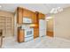 Charming kitchen with white appliances, wood cabinetry, and tile flooring creating an inviting culinary space at 2698 S Niagara St, Denver, CO 80224