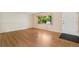Well-lit living room offers gleaming hardwood floors, a bay window, and neutral walls at 2698 S Niagara St, Denver, CO 80224