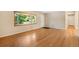 Inviting living room boasts gleaming hardwood floors, a bay window, and a neutral color palette at 2698 S Niagara St, Denver, CO 80224