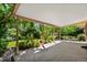 Covered patio overlooking a lush garden with roses and mature trees at 2698 S Niagara St, Denver, CO 80224