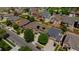 Aerial view of neighborhood showcasing mature trees, well-maintained lawns, and close proximity to local park at 16643 E 101St Ave, Commerce City, CO 80022