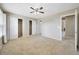 Neutral bedroom features carpet floors, ceiling fan, and double door closets at 16643 E 101St Ave, Commerce City, CO 80022