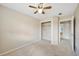Cozy bedroom with neutral walls, ceiling fan, and closet with shelving at 16643 E 101St Ave, Commerce City, CO 80022