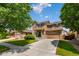Charming two-story home with a well-manicured lawn, stone accents, and an attached two-car garage at 16643 E 101St Ave, Commerce City, CO 80022