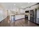 Bright kitchen with white cabinets, stainless steel appliances, and dark hardwood floors at 16643 E 101St Ave, Commerce City, CO 80022