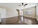 Spacious living room with hardwood floors, a ceiling fan, and ample natural light at 16643 E 101St Ave, Commerce City, CO 80022