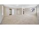 Spacious living room features neutral carpeting, fresh paint, and plenty of natural light at 16643 E 101St Ave, Commerce City, CO 80022