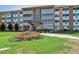 Attractive building exterior with manicured lawns and colorful flowers enhancing the overall appeal and entrance at 795 S Alton Way # 4C, Denver, CO 80247