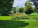 Beautifully maintained green space with flower beds and mature trees at 795 S Alton Way # 4C, Denver, CO 80247