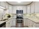 Well-lit kitchen with granite countertops, stainless steel appliances, and white cabinets at 795 S Alton Way # 4C, Denver, CO 80247