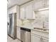 This updated kitchen features white cabinets, granite countertops, and stainless steel appliances at 795 S Alton Way # 4C, Denver, CO 80247