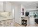 Bright kitchen features white cabinets, granite counters, stylish backsplash, and adjacent bar seating area at 795 S Alton Way # 4C, Denver, CO 80247