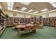 Community library featuring bookshelves filled with books, tables with reading space, and comfortable chairs at 795 S Alton Way # 4C, Denver, CO 80247