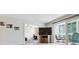 Open-concept living room features hardwood floors, sliding glass doors to the patio, and an entertainment center at 795 S Alton Way # 4C, Denver, CO 80247