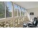 Sunroom features many windows overlooking a green outdoor landscape at 795 S Alton Way # 4C, Denver, CO 80247