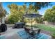 Backyard patio with outdoor dining, a hot tub, and a lush green lawn at 3582 Wright St, Wheat Ridge, CO 80033