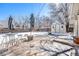 Backyard patio featuring a dining area, with a shed in the snowy yard at 3582 Wright St, Wheat Ridge, CO 80033