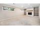 Spacious basement featuring a fireplace, built-in bookshelves and large windows at 3582 Wright St, Wheat Ridge, CO 80033