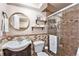 Well-lit bathroom featuring modern tile, a glass-enclosed shower, and stylish fixtures at 3582 Wright St, Wheat Ridge, CO 80033