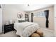 Cozy bedroom with stylish decor, including a round mirror and decorative ladder shelf at 3582 Wright St, Wheat Ridge, CO 80033