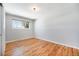 Minimalist bedroom features hardwood floors, natural light, neutral paint colors, and modern fixtures at 3582 Wright St, Wheat Ridge, CO 80033