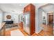 Kitchen and entry feature stainless steel refrigerator, wood floors, and granite countertop bar area at 3582 Wright St, Wheat Ridge, CO 80033