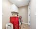 Laundry room with a vibrant red washer and dryer, and ample storage at 3582 Wright St, Wheat Ridge, CO 80033