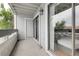 Exterior view of a condo balcony with white wood and door leading to seating area inside through sliding glass doors at 14214 E 1St Dr # B08, Aurora, CO 80011