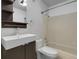 Cozy bathroom features a tiled shower-tub, modern sink with storage, and neutral tones at 14214 E 1St Dr # B08, Aurora, CO 80011