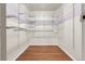 Walk-in closet with custom shelving, offering ample storage and organization space at 14214 E 1St Dr # B08, Aurora, CO 80011