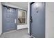View of a condo entrance featuring unit door, utility door, window, and carpeted floor in shared space at 14214 E 1St Dr # B08, Aurora, CO 80011
