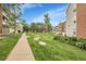 Community exterior with beautiful landscaping, grassy area and walkways at 14214 E 1St Dr # B08, Aurora, CO 80011