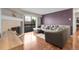 Inviting living room with fireplace, modern decor, balcony access, and hardwood floors at 14214 E 1St Dr # B08, Aurora, CO 80011