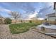 Spacious backyard featuring a green lawn, wooden fence, and patio seating area at 3268 E 136Th Pl, Thornton, CO 80602