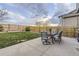 Beautiful backyard with a well-maintained lawn, wooden fence, and patio seating area at 3268 E 136Th Pl, Thornton, CO 80602