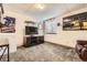 Finished basement featuring carpeted floors and Denver Broncos decor at 3268 E 136Th Pl, Thornton, CO 80602