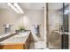Bright bathroom featuring a granite countertop, modern vanity, and glass-enclosed shower at 3268 E 136Th Pl, Thornton, CO 80602