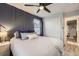 Stylish bedroom featuring a modern design with a dark accent wall and ample natural light at 3268 E 136Th Pl, Thornton, CO 80602