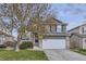 Charming two-story home with a well-maintained lawn and a two car attached garage at 3268 E 136Th Pl, Thornton, CO 80602