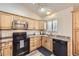 Cozy kitchen with light wood cabinetry, stainless steel appliances, and modern fixtures at 3268 E 136Th Pl, Thornton, CO 80602