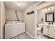 Convenient laundry area with washer, dryer, and access to an updated half bathroom at 3268 E 136Th Pl, Thornton, CO 80602