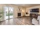 Inviting living room with a fireplace, wood floors, and sliding door access to the backyard at 3268 E 136Th Pl, Thornton, CO 80602