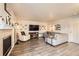 Cozy living room features hardwood floors, a fireplace, and comfortable seating arrangement at 3268 E 136Th Pl, Thornton, CO 80602