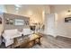 Comfortable seating area with a view of the stairs and an open-concept dining area at 3268 E 136Th Pl, Thornton, CO 80602