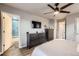 Bedroom with ceiling fan, hardwood floors, and an ensuite bathroom for added convenience at 3268 E 136Th Pl, Thornton, CO 80602