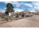 Expansive backyard with a pergola, mature trees, and a wooden fence, creating a private and inviting outdoor space at 7794 Louviers Blvd, Louviers, CO 80131