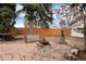 Tranquil backyard with mature trees, a stone fire pit, and comfortable seating, perfect for relaxation and outdoor gatherings at 7794 Louviers Blvd, Louviers, CO 80131