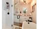 Bright bathroom showcasing a glass shower, a soaking tub, dual sinks, and decorative accents at 7794 Louviers Blvd, Louviers, CO 80131